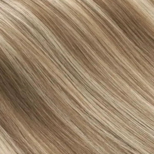Close-up of brown and blonde clip-in human hair extensions in shade cappuccino